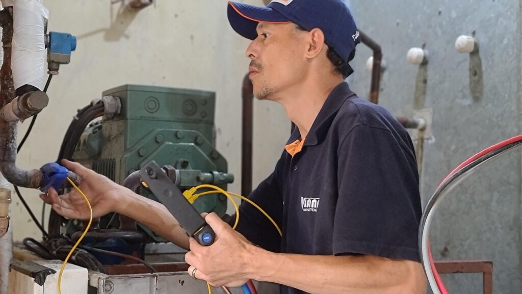 refrigerator technician inspecting cooling system