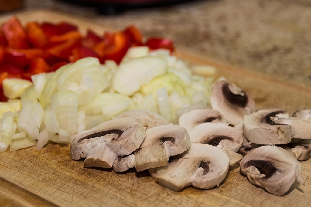wooden cutting board sprayed with white vinegar for sanitizing in kitchen