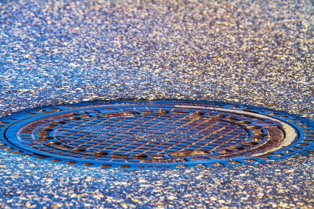 rubber gloves removing hair from drain cover