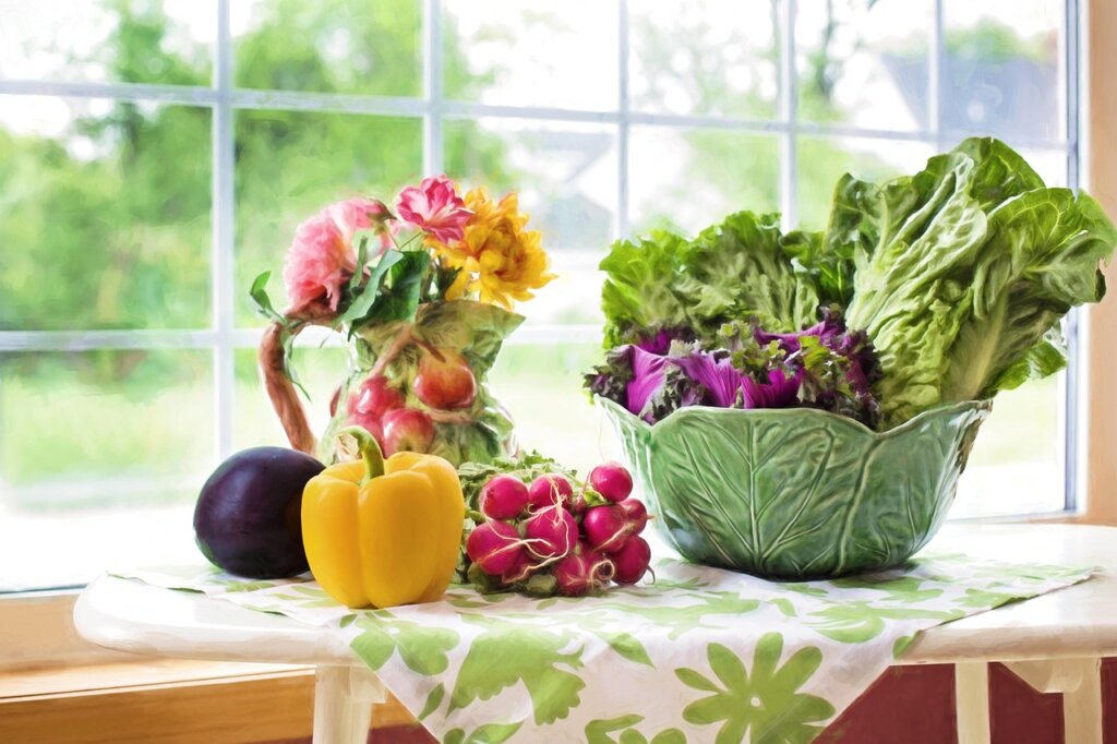 hands squeezing vegetable scraps in kitchen paper towel, bright light