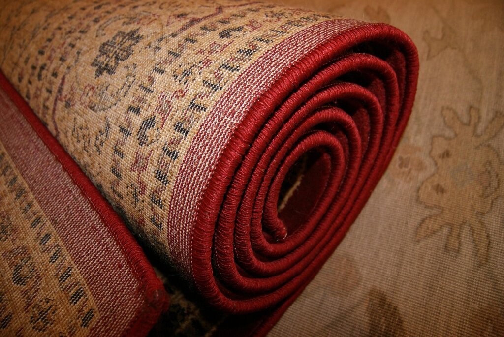 carpet protector spray being applied on rug