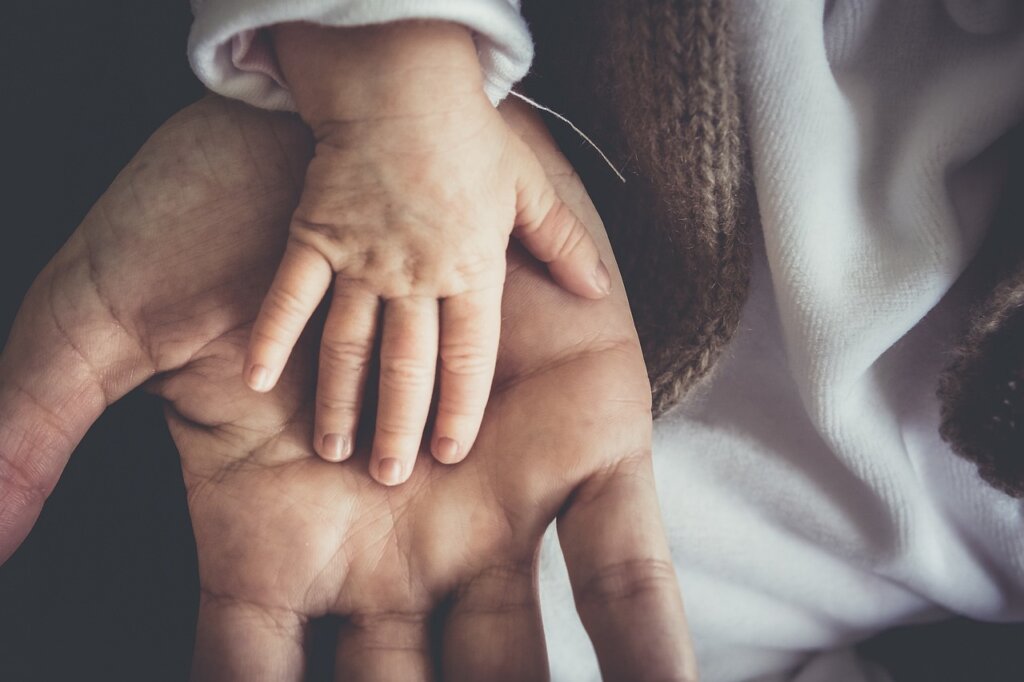 adult child helping elderly parent with laundry