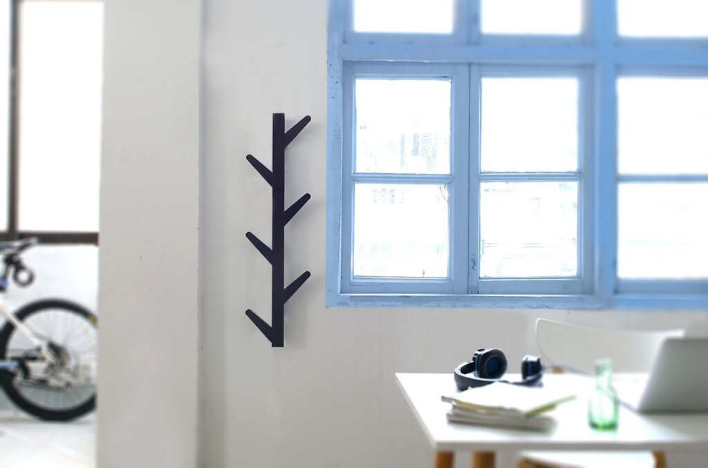 wall-mounted hooks and shelves maximizing vertical space in laundry room