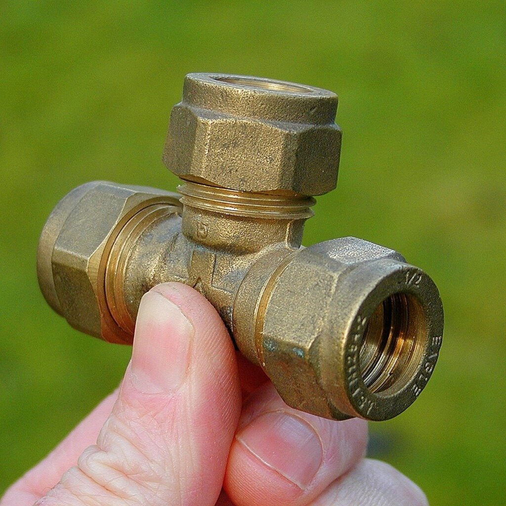 PTFE thread seal tape being wrapped around pipe fitting bathroom plumbing
