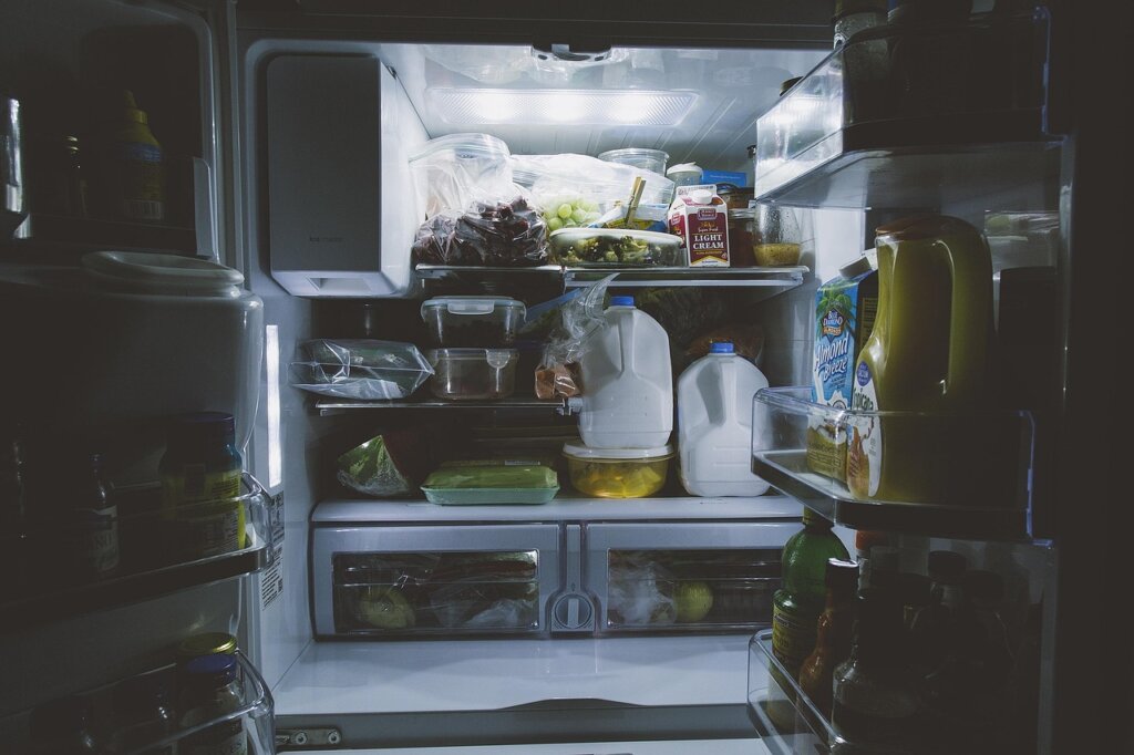 baking soda in open container inside refrigerator shelf