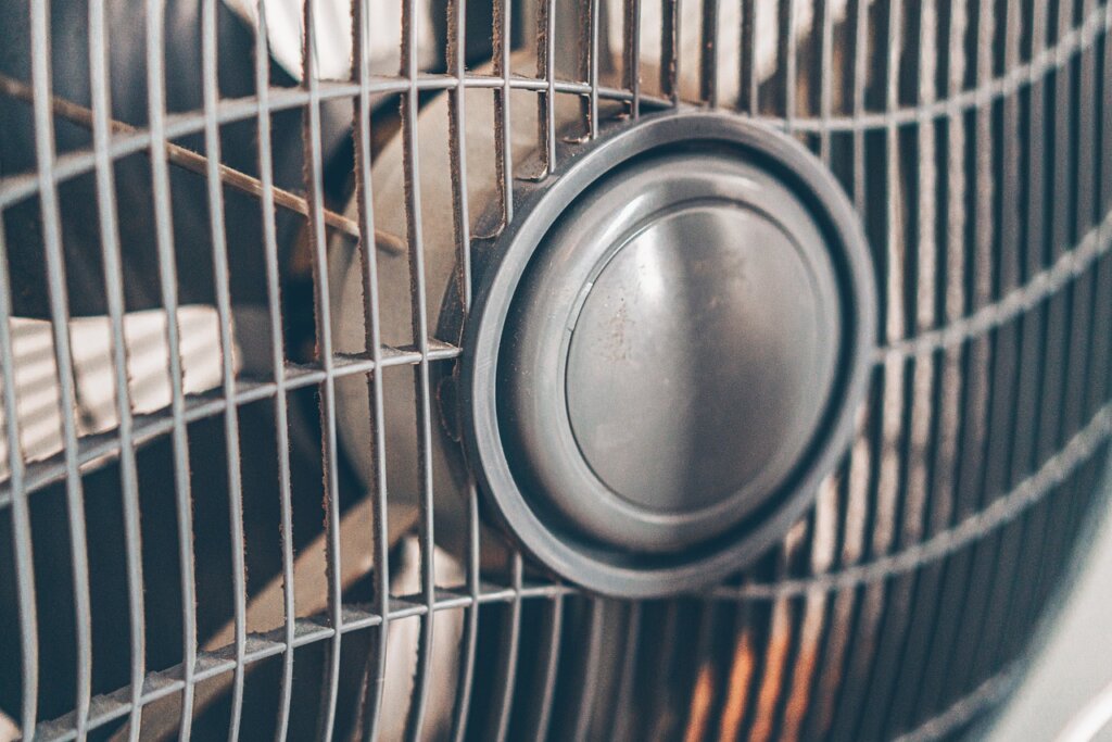 bathroom exhaust fan motor and blade detail showing dust accumulation on fan blades