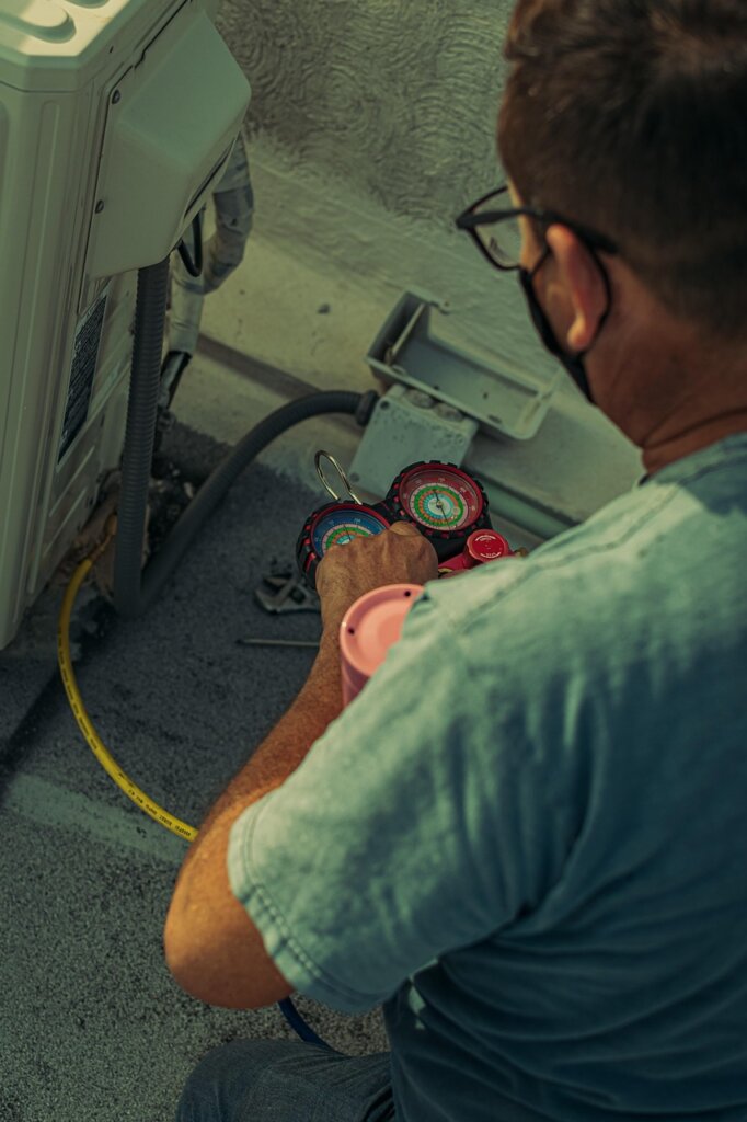 professional technician cleaning air conditioner internal parts with steam