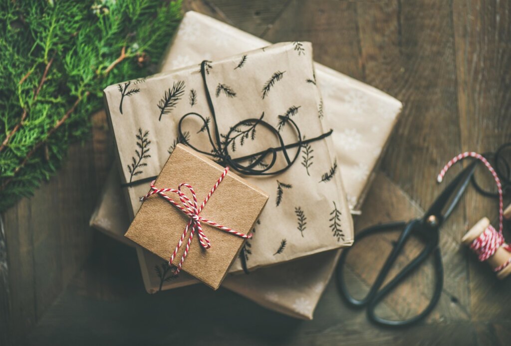 gift set of bathroom cleaning products with ribbon on wooden table