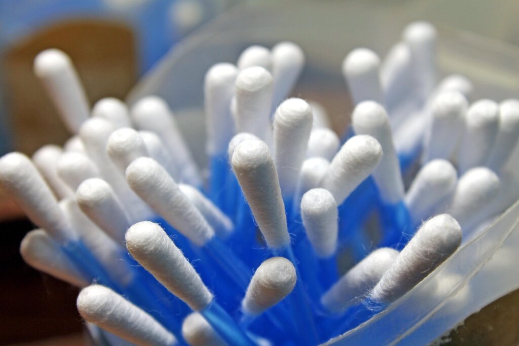 electronic toy being cleaned with cotton swab and alcohol