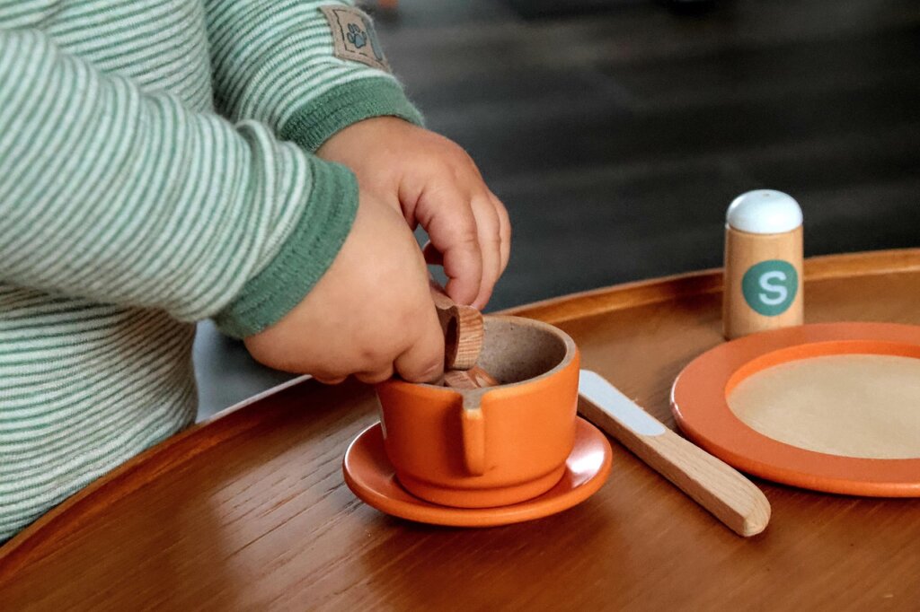wooden montessori toys drying in sunlight on wooden table