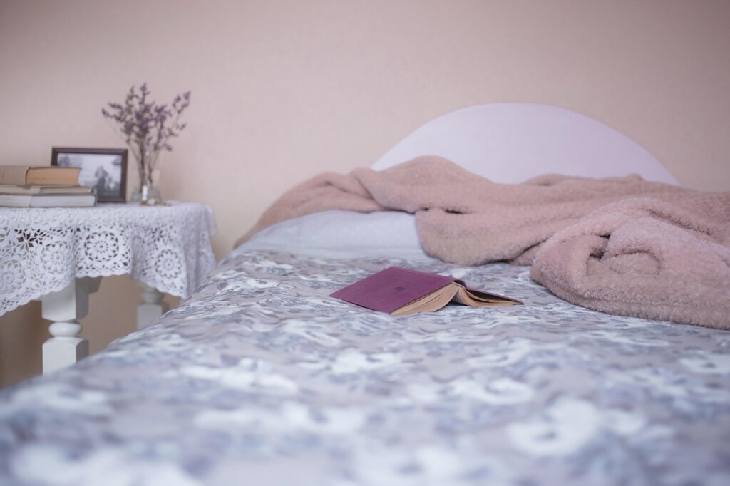 bed sheets pile laundry basket bedroom