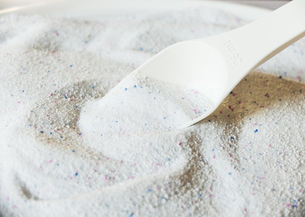 liquid laundry detergent poured into washing machine drawer