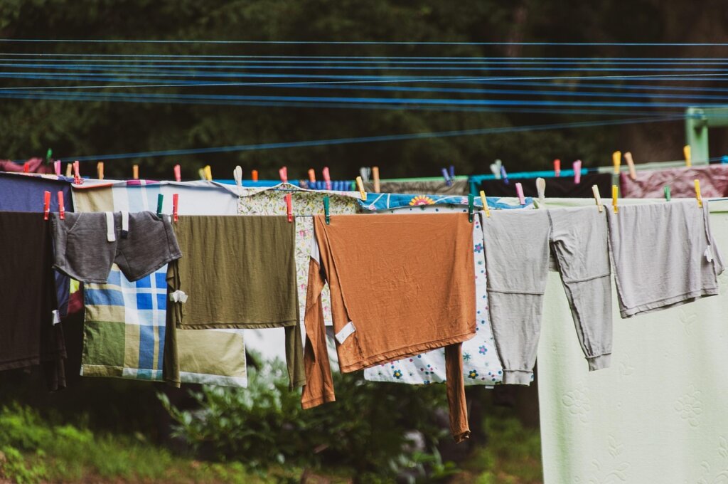 white duvet drying on clothesline outdoor sunny day