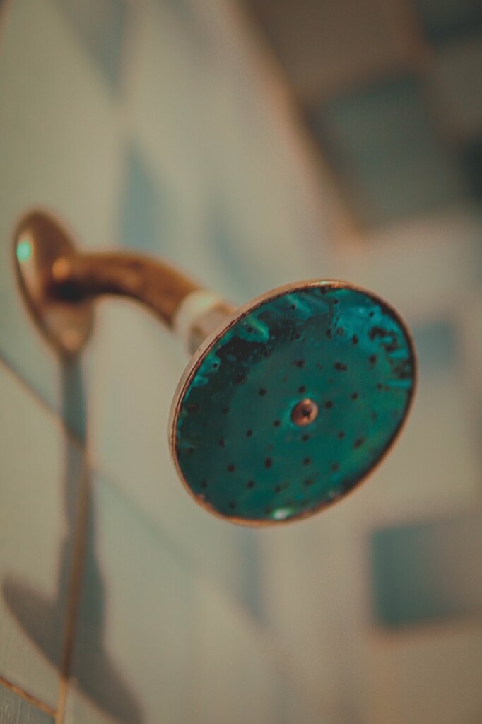bathroom showerhead clogged with limescale close-up